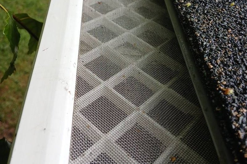 Close-up of micro-mesh gutter protection installed on an eavestrough